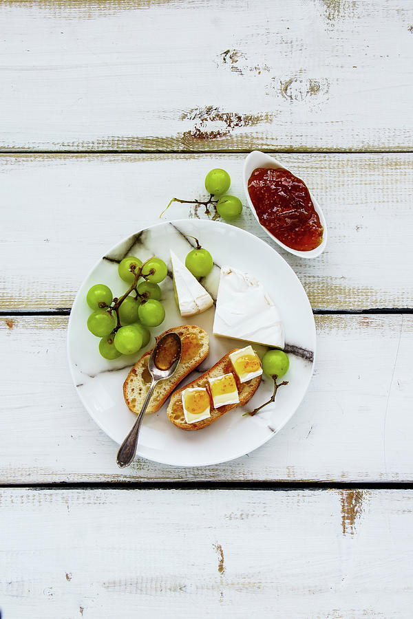 Tasty Breakfast Set On White Wooden Table. Brie Cheese And Fig Jam Sandwiches With Fresh Grapes Over Rustic Background Photograph by Yuliya Gontar