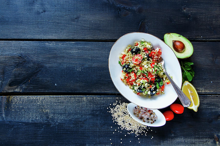 Tasty Organic Quinoa Salad With Feta Cheese, Cherry Tomatoes, Avocado, Black Olives In Bowl On Dark Rustic Wooden Background Photograph by Yuliya Gontar