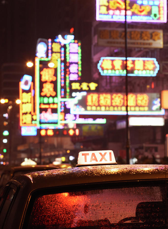 Taxi Along Nathan Road At Night Photograph by Gary Yeowell