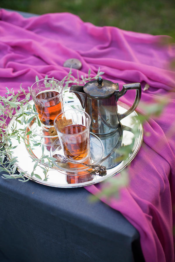 Tea Glasses And Silver Teapot On Tray With Leafy Twigs Photograph by Alicja Koll