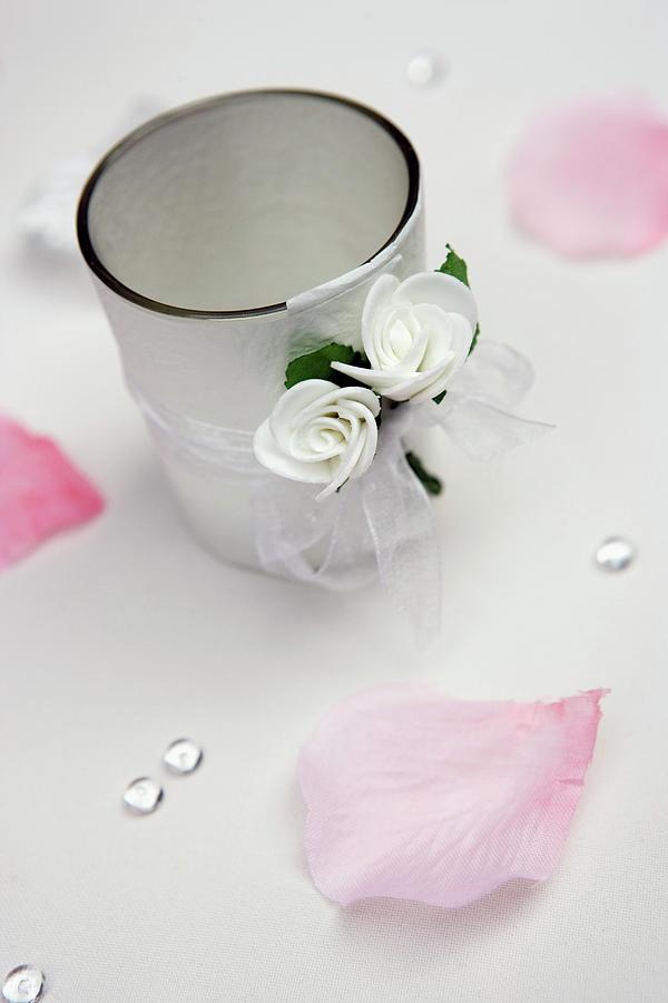 Tealight Holder Decorated With Ribbon And White Flowers Amongst Scattered Rose Petals Photograph by Lydie Besancon