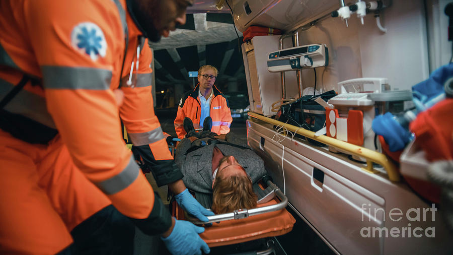 Team Of Paramedics Treating Injured Patient In Ambulance Photograph by Gorodenkoff Productions/science Photo Library