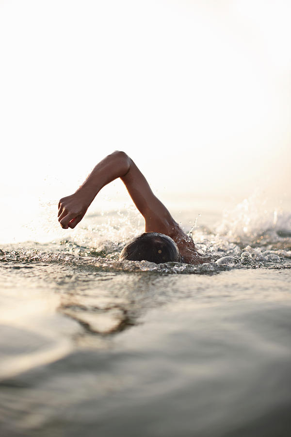 Teenage Boy Swimming In Water Photograph by Niels Busch