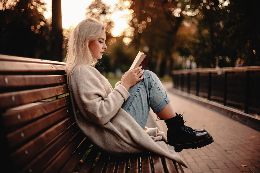 Girl Sitting Alone On Bench Reading