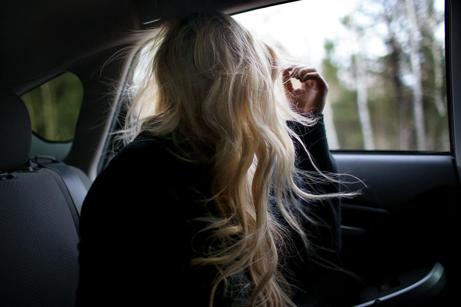 Teenager With Long Hair Looking Through Window In Car Photograph by ...