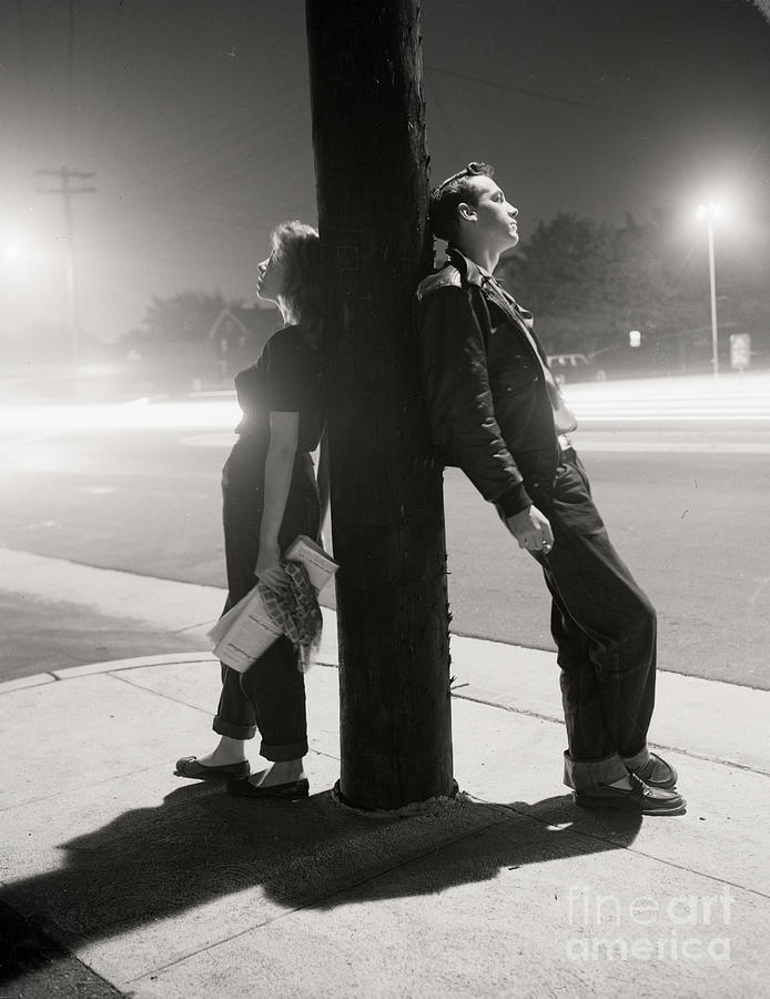Teenagers Leaning On Utility Pole Photograph by Bettmann