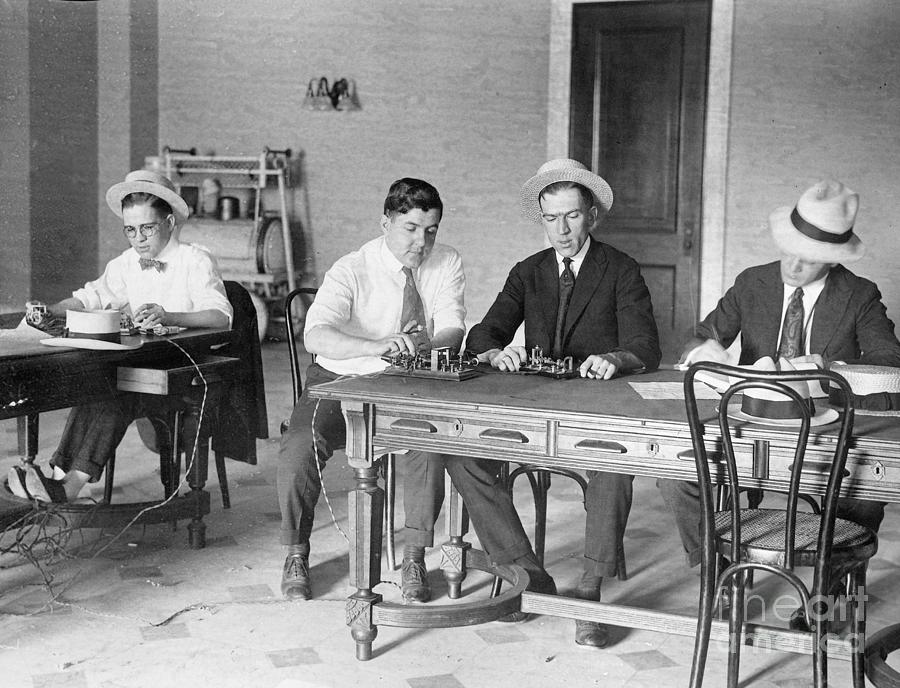Telegraph Men Seated At Table Photograph by Bettmann