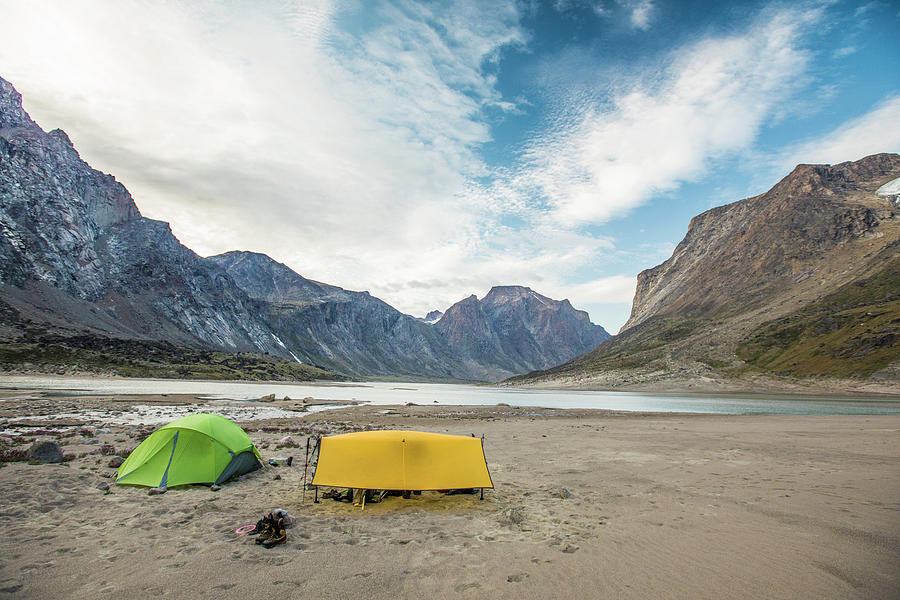 Mountain Photograph - Tents Set Up On A Sandy Beach Below Mountain Peaks. by Cavan Images