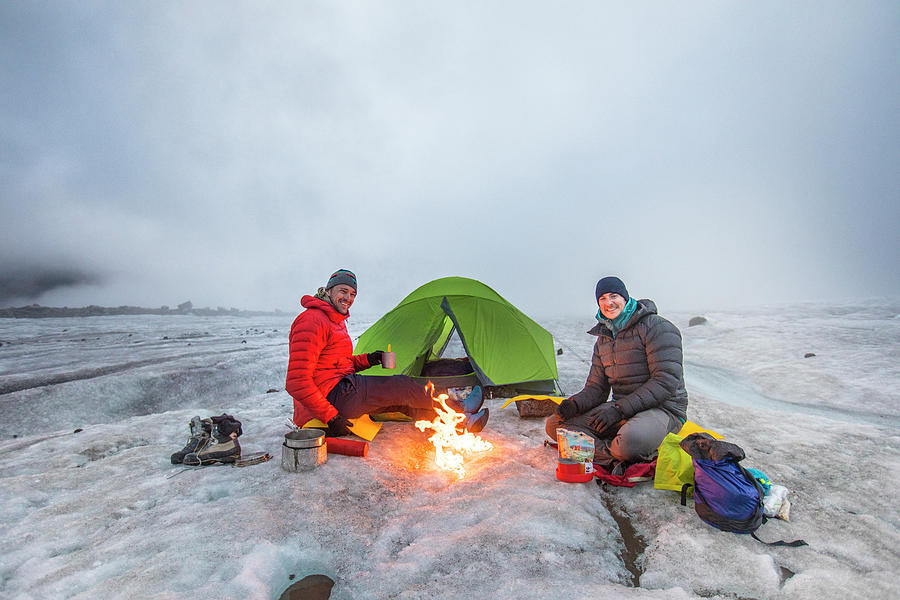 Mountain Photograph - Teo Mountaineers Enjoys Campfire While Camping On A Glacier. by Cavan Images