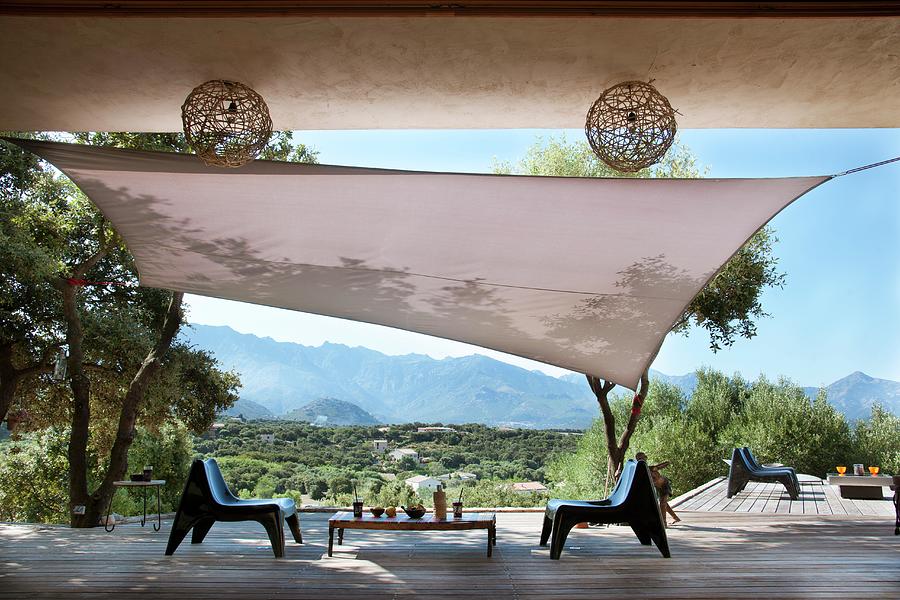 Terrace With Wooden Floor, Awning, Olive Trees And Modern Plastic Chairs Photograph by Christophe Madamour