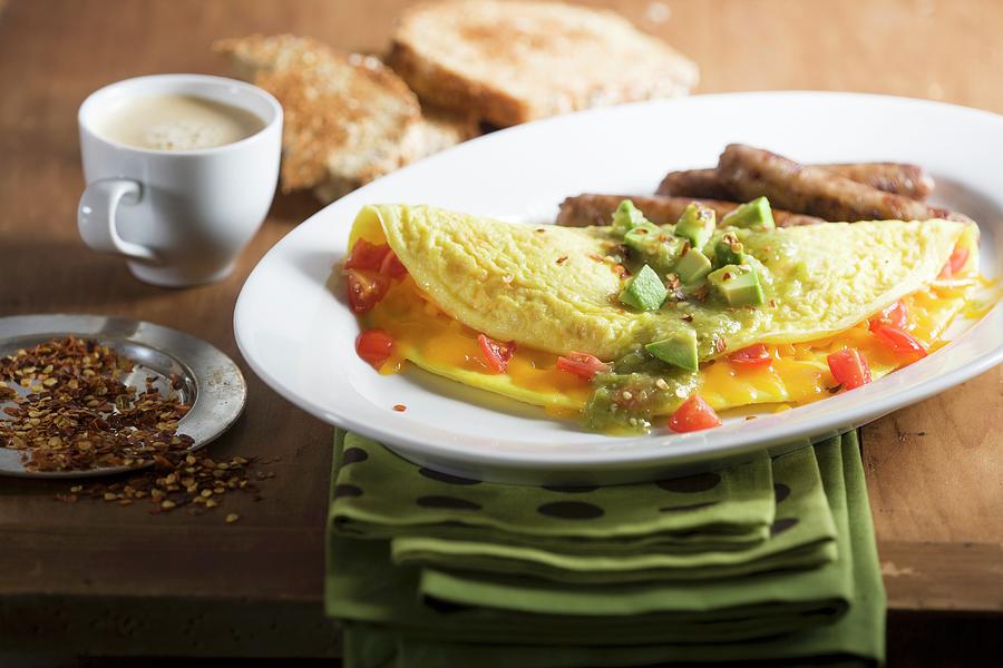 Tex-mex Omelette With Avocados And Sausages Photograph by John Gagne
