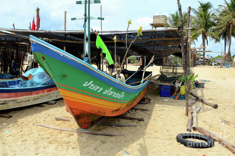 Thai fishing boat bow parked on logs on beach sand at village in Pattani Thailand Photograph by Imran Ahmed
