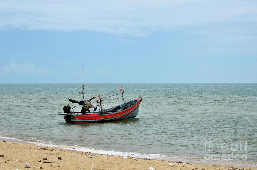 Thai fishing boat with motor parked at sea by beach in Pattani fishing village Thailand Photograph by Imran Ahmed