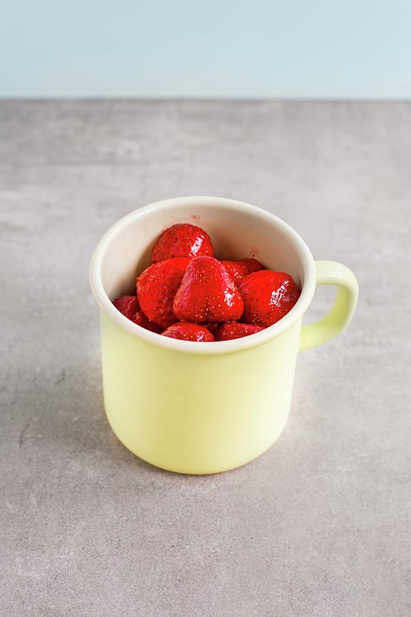 Thawed Strawberries In An Enamel Mug Photograph by Tina Engel