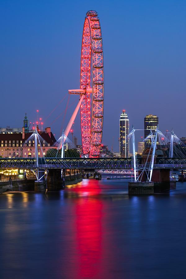 The beautiful London eye in England seen at blue hour. Photograph by George Afostovremea