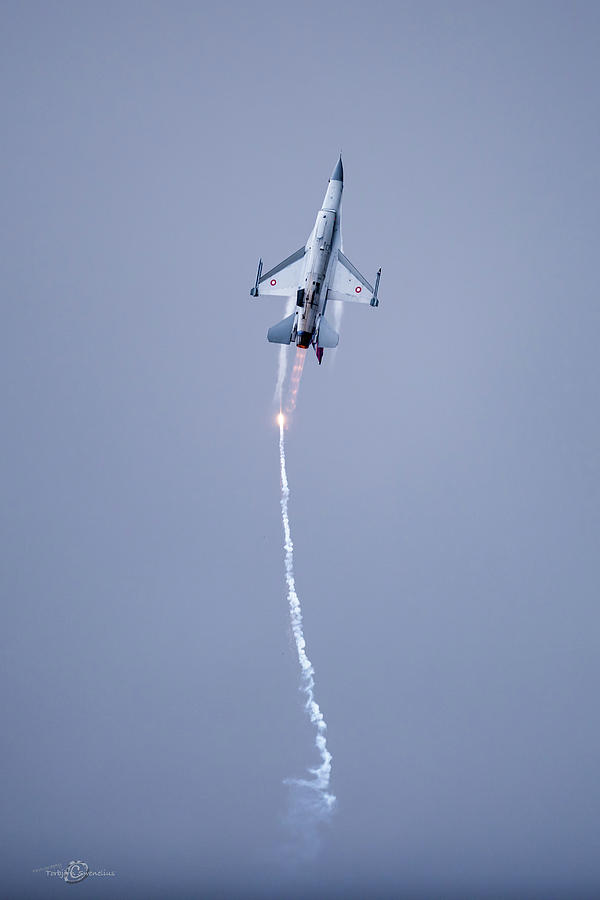 The Danish F-16 Fighting Falcon in high speed action dropping flares Photograph by Torbjorn Swenelius