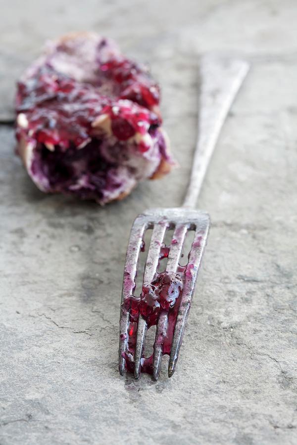 The End Of A Bread Roll And A Fork Covered With Remnants Of Blueberry Jam Photograph by Schindler, Martina