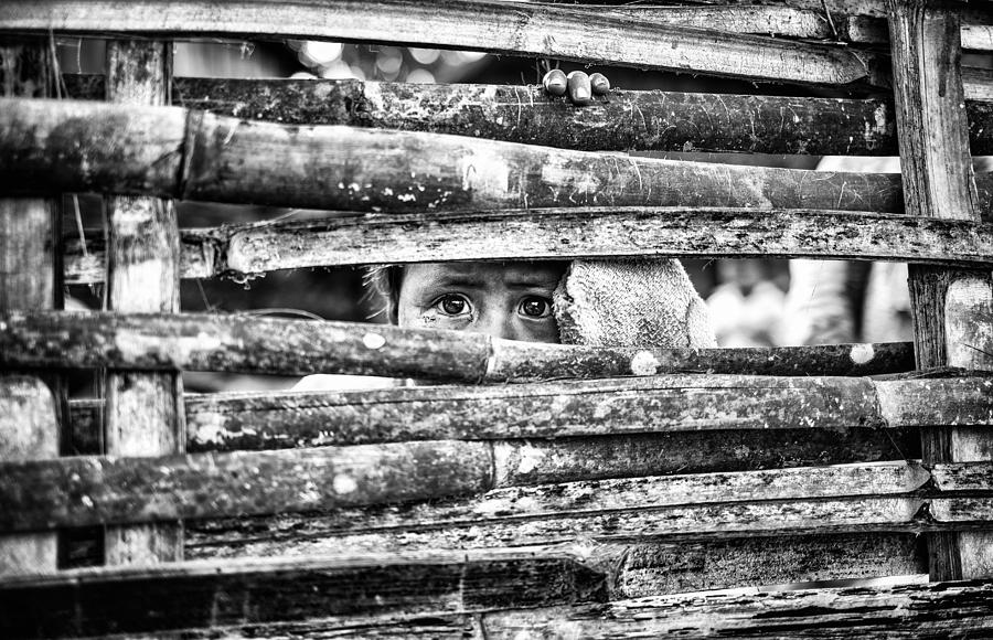 Documentary Photograph - The Eyes Behind The Fence by Marco Tagliarino