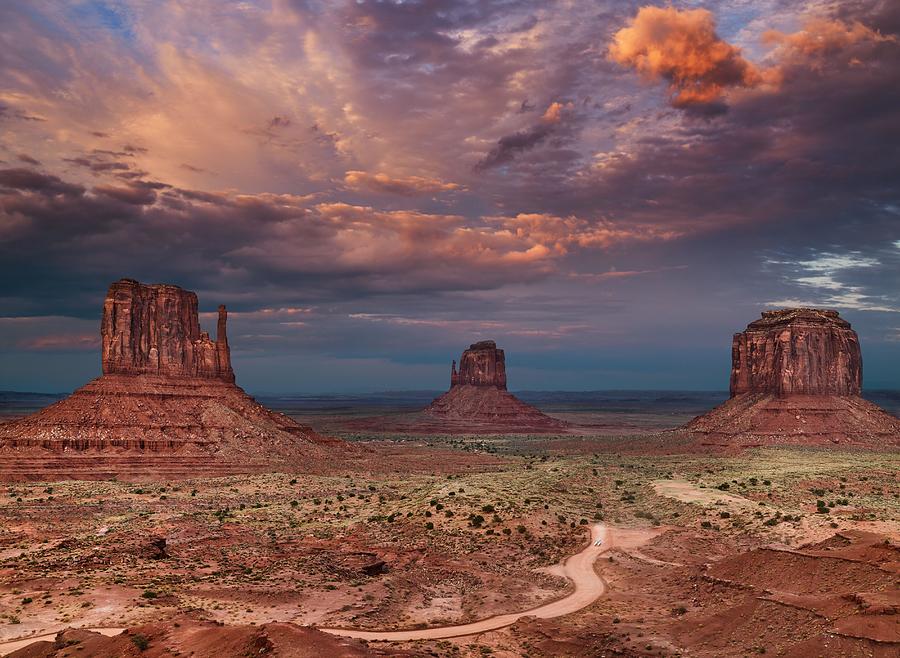 Sunset Photograph - The Famous Buttes Of Monument Valley by DPK-Photo