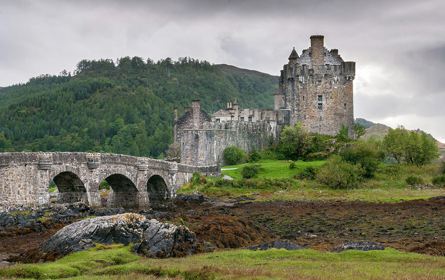 The famous Eilean Donan Castle in the lake of Loch Alsh  at the  Photograph by Michalakis Ppalis