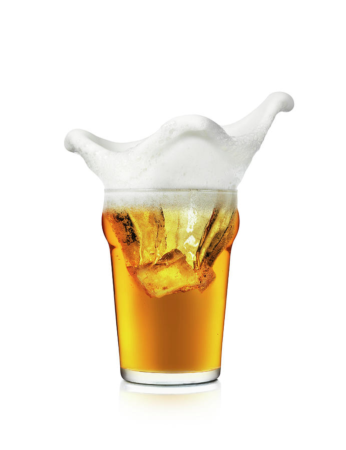 The Foam On A Glass Of Beer Splashing Photograph by Kedsanee