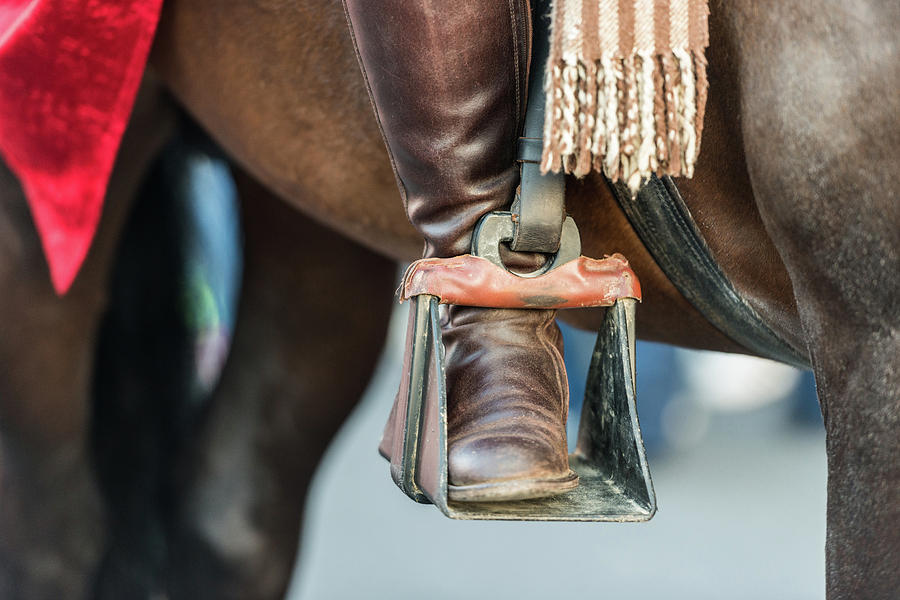 The Foot Of A Rider On The Stirrup Of A Horse During The Celebration Of St. George And The Dragon In Photograph