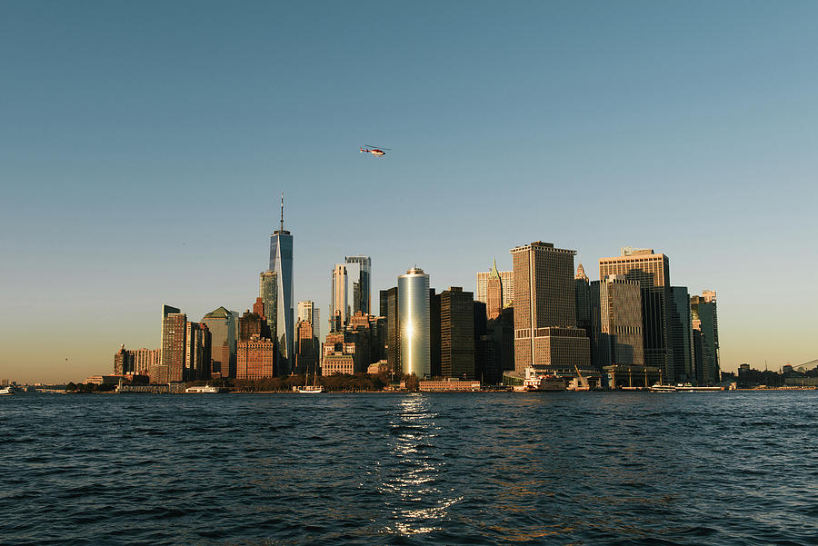 Sunset Photograph - The New York City Skyline Of Southern Manhattan Seen From Water by Cavan Images