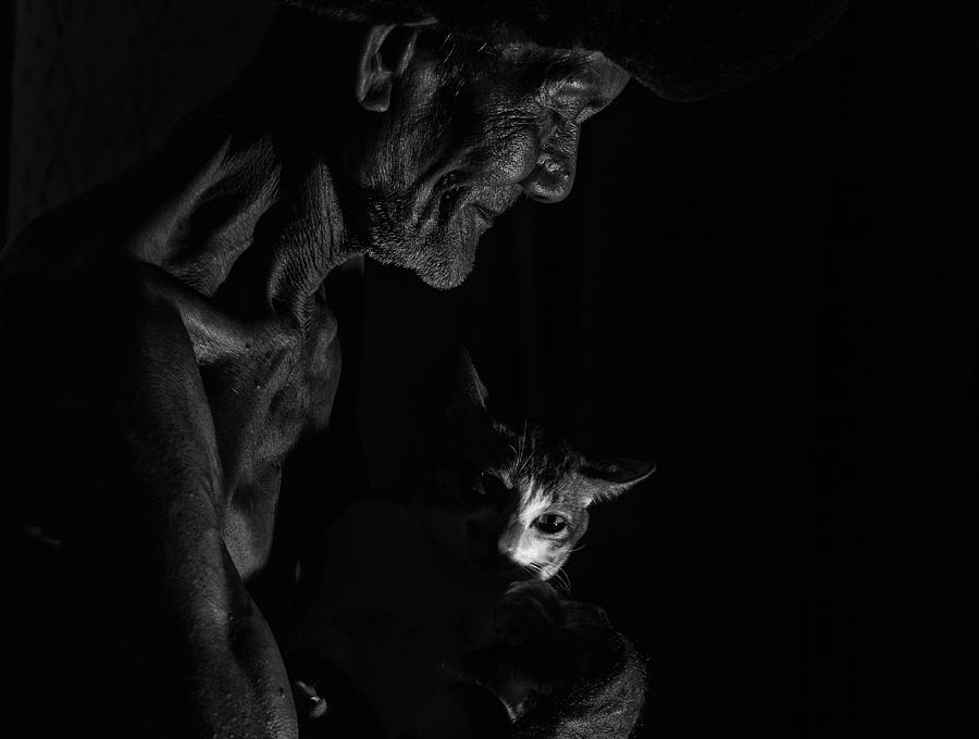 Black And White Photograph - The Old Man And His Cat by Andi Halil