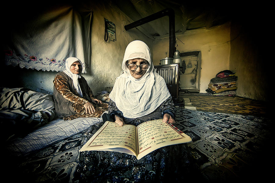 The Old Woman Is Reading The Koran. Photograph by Mehmet etin