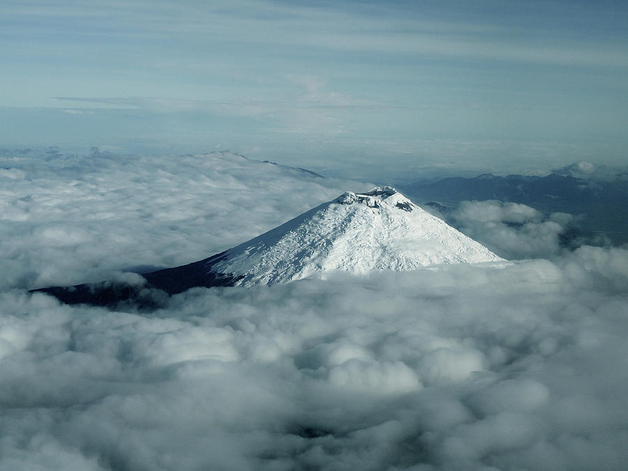 The peak of the Cotopaxi volcano standing above the clouds in th ...