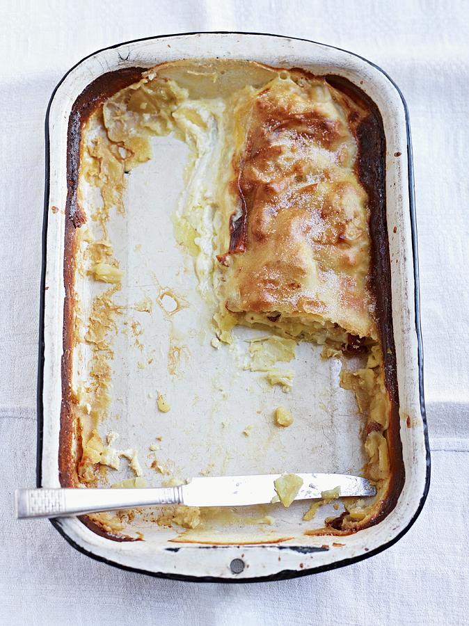The Remains Of Creamy Strudel In A Baking Dish Photograph by Oliver Brachat