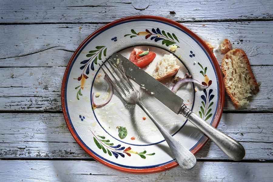 The Remains Of Food And Bread On An Empty Plate Photograph by Piga & Catalano S.n.c.
