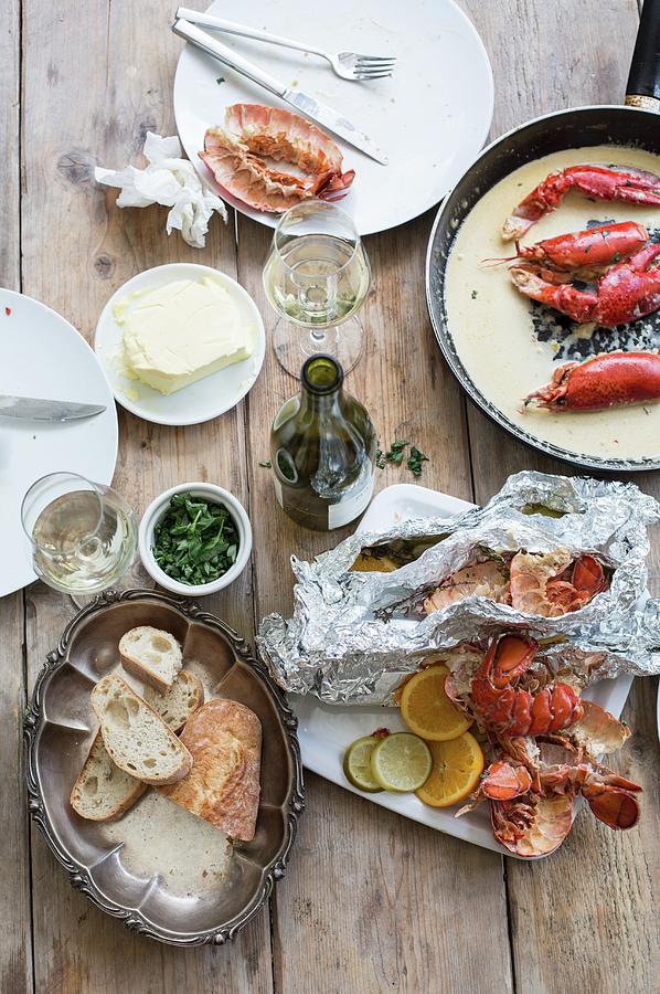 The Remains Of Lobster, Bread And Wine After A Meal Photograph by Sabine Steffens