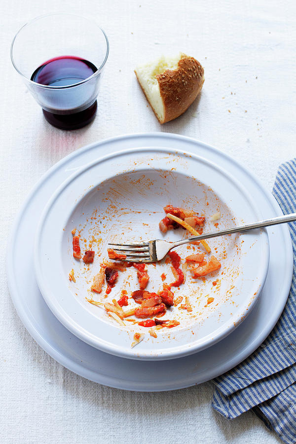 The Remains Of Spaghetti Allamatriciana On A Plate Photograph by Marie Sjoberg