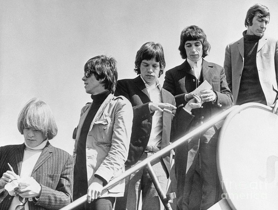 The Rolling Stones Getting Off Plane Photograph by Bettmann The Rolling Stones Getting Off Plane Photograph by Bettmann