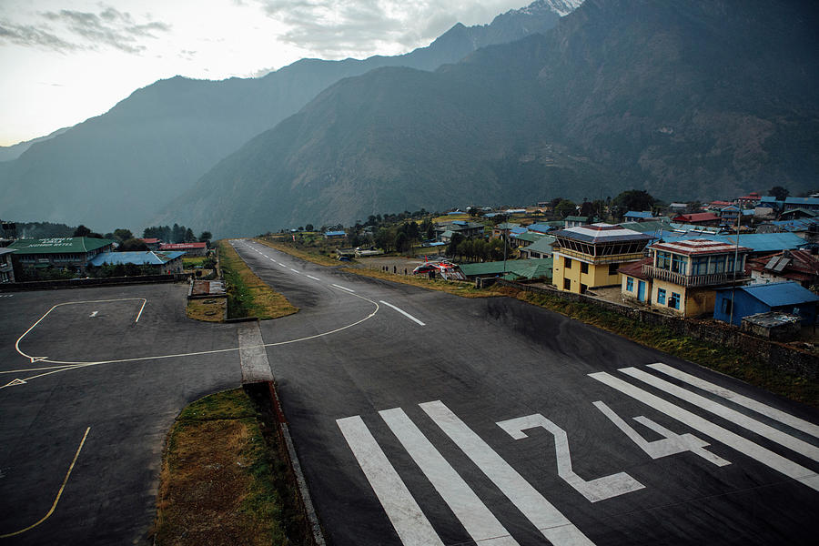 Nature Photograph - The Sloped Runway In Lukla, The Gateway To Nepals Khumbu Valley. by Cavan Images