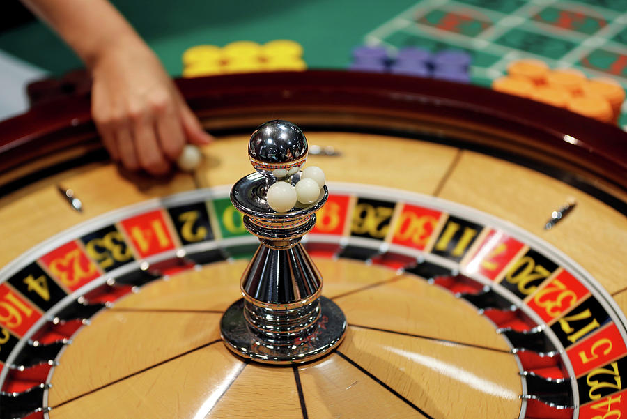 The Spinning Wheel on a Roulette Table Photograph by Toru Hanai - Fine ...