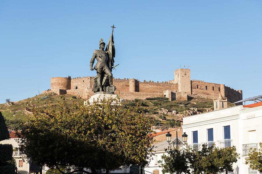 The Statue Of Courtly Hernan With Castle Of Medellin In The Background, Extremadura, Spain.medellin, Photograph