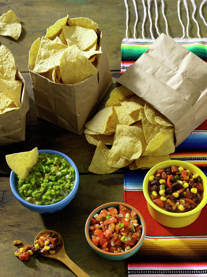 Three Bags Of Tortilla Chips Served With A Trio Of Salsa mexico Photograph by Janellephoto