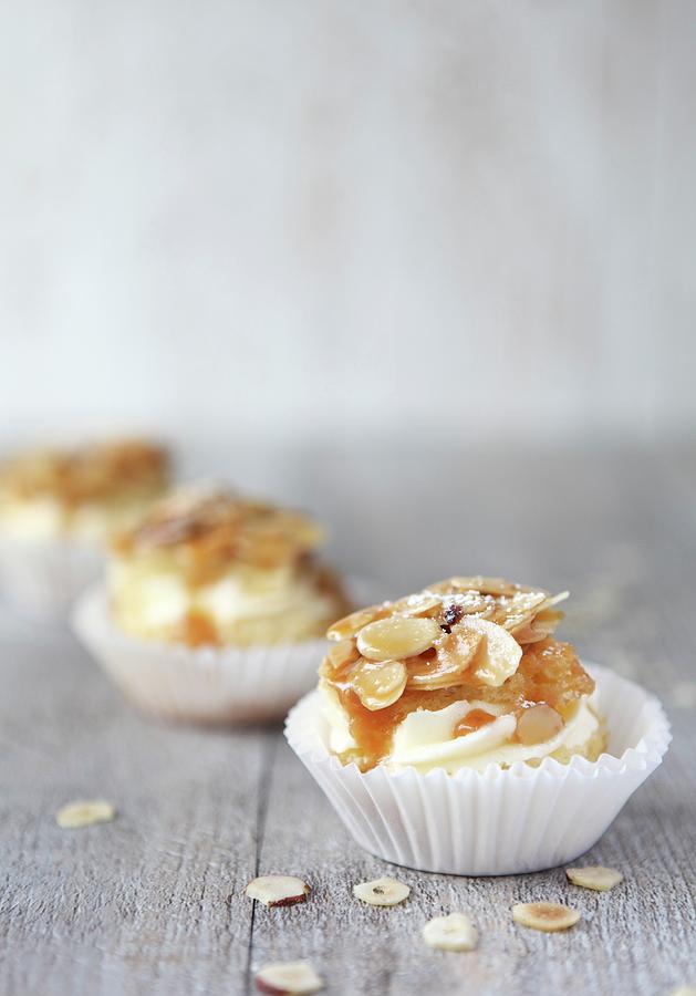 Three Bienenstich Muffins caramelised Almond Cake On A Wooden Surface Photograph by Sabrina Sue Daniels