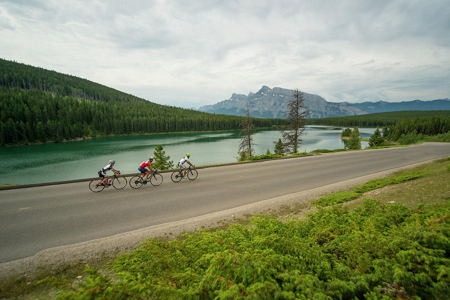 Three Bikers Pedal Down Quiet Mountain Photograph by Ascent Xmedia