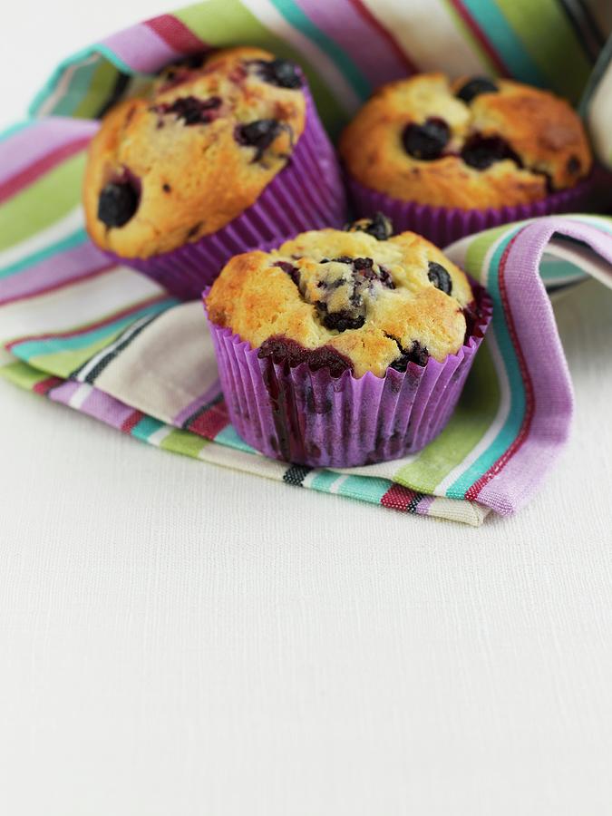 Three Blueberry Muffins In A Stripped Cloth Photograph by Geoff Fenney