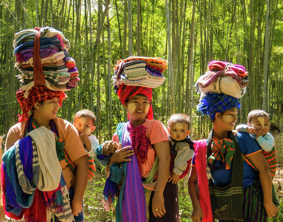 Three Burmese mothers with their babies tied on their back Photograph by Ann Moore