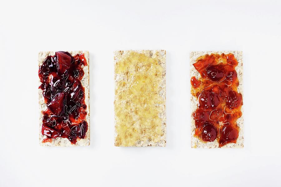 Three Crispbreads With Jam And Honey seen From Above Photograph by Jan Prerovsky