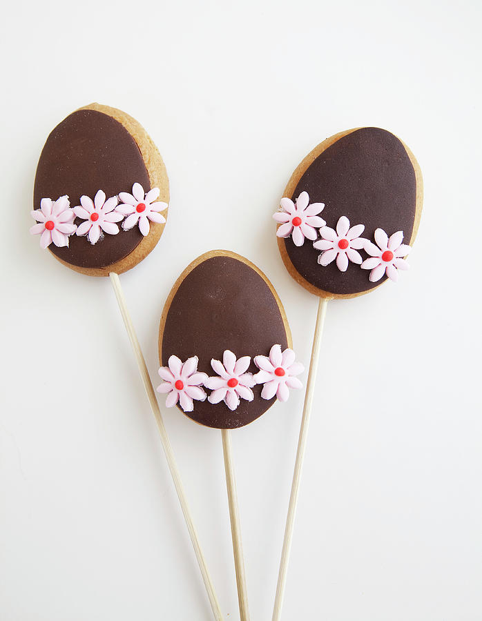 Three Decorated Easter Egg Shaped Cookies On A Stick Photograph by Trudy Kelder