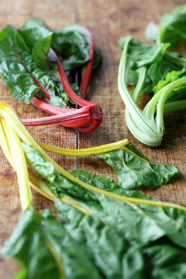 Three Different Kinds Of Chard On A Wooden Board Photograph by Mona Binner Photographie