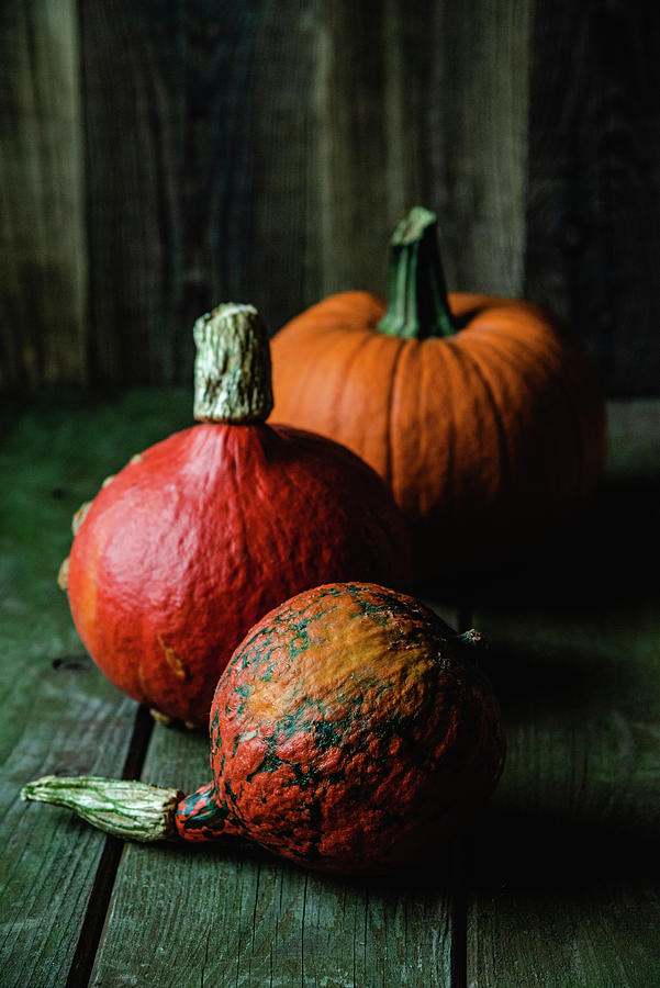Three Different Pumpkins On A Wooden Background Photograph by Joanna Stolowicz