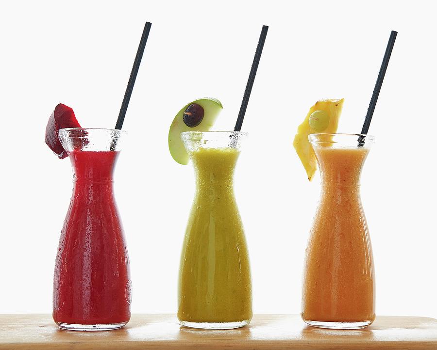 Three Different Smoothies In Carafes Photograph by Robbert Koene