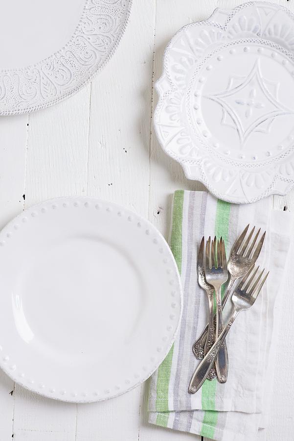 Three Different White Plates And Silver Cutlery On A Fabric Napkin Photograph by Farrell Scott