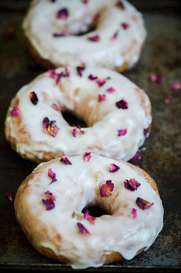 Three Doughnuts Sprinkled With Dried Rose Petals Photograph by Donna Crous